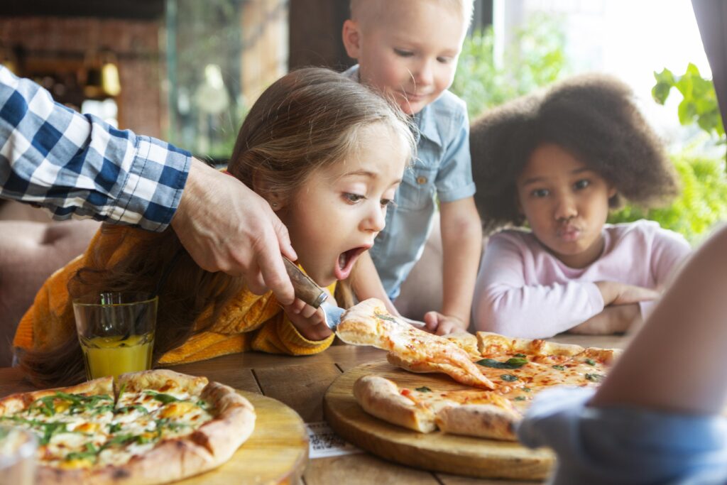 Kids eating pizza in a restaurant